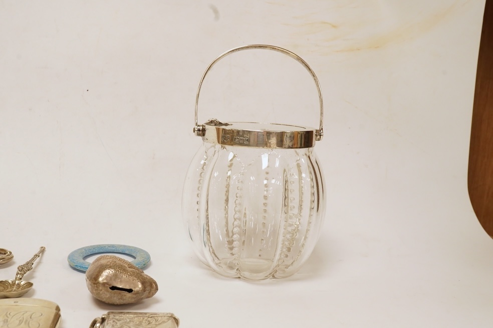 A late Victorian silver mounted glass preserve jar by Goldsmiths & Silversmiths Co Ltd, London, 1899, height 14.5cm including handle, together with two silver vesta cases, a modern silver mounted wine coaster, four items